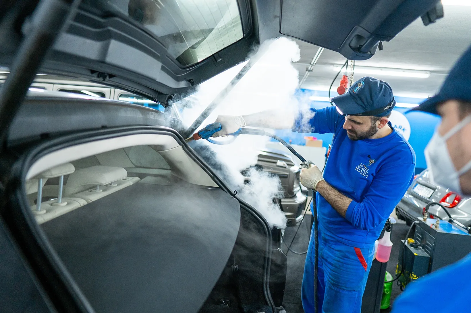 The Parknwash team steam-cleans a vehicle boot.