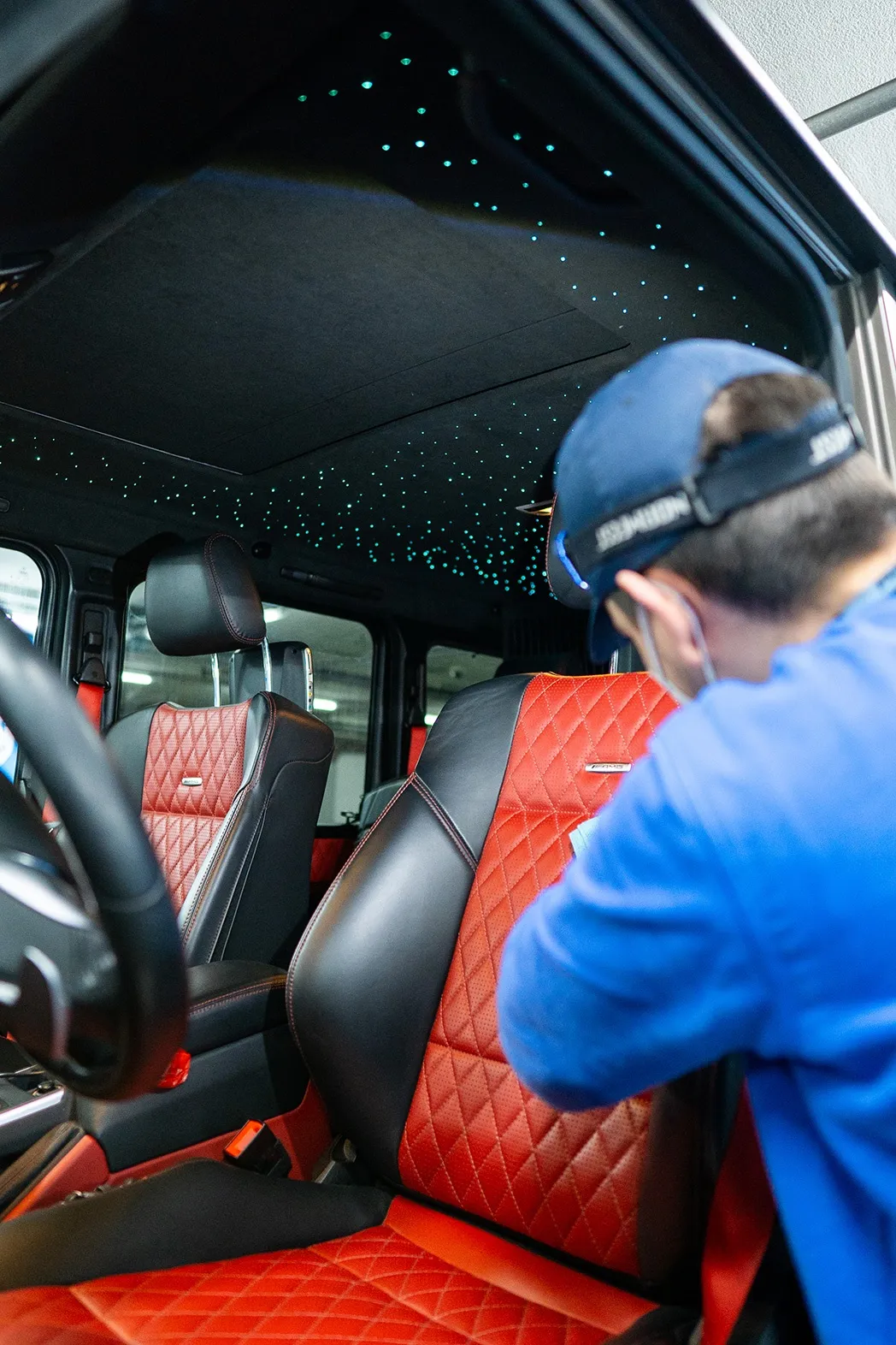 A Parknwash team member works on a vehicle interior.
