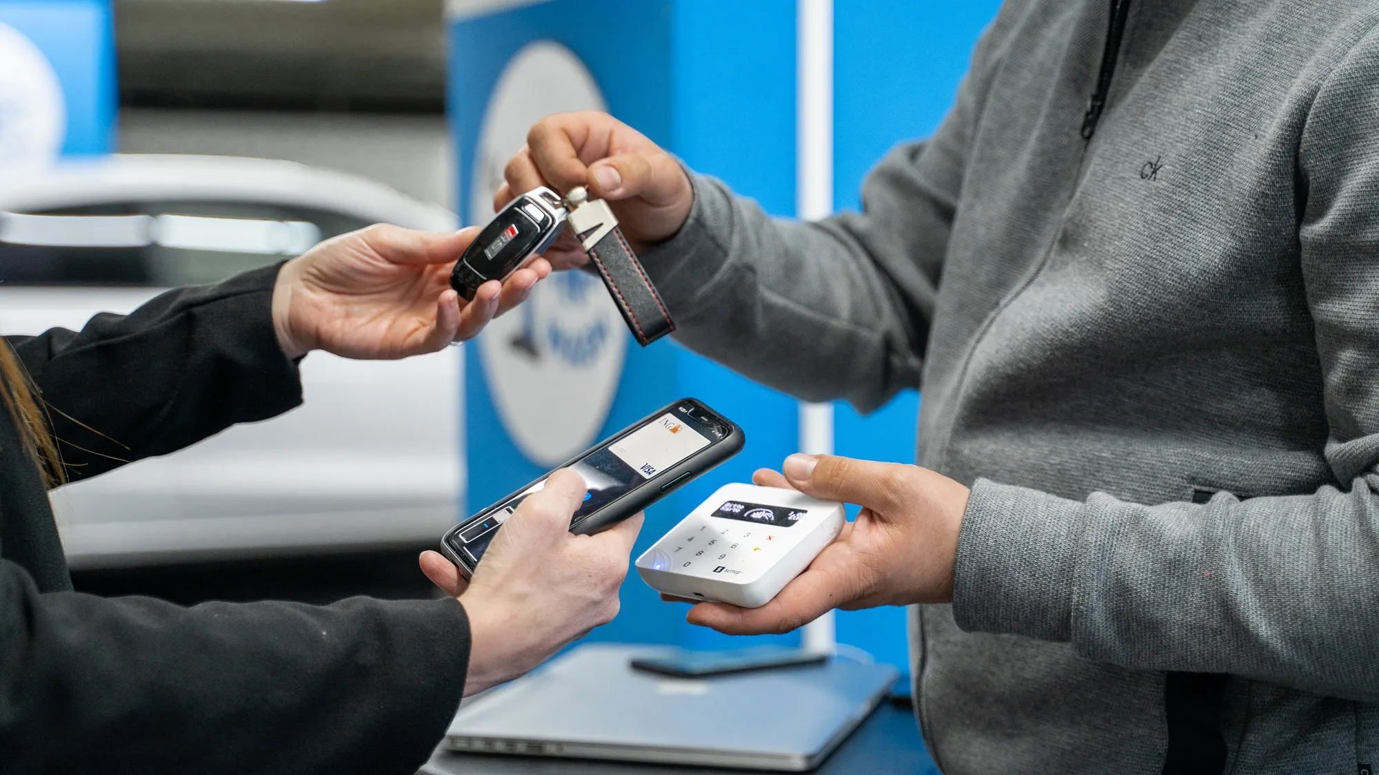 Handing over a vehicle key and payment after vehicle care.